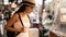 Young brunette woman traveler looking at traditional street food stalls in china town market in Asia.