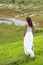 Young brunette woman turning her back posing against the background of rice fields