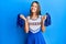 Young brunette woman wearing cheerleader uniform smiling with a happy and cool smile on face