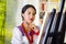 Young brunette woman wearing traditional andean clothing painting on canvas inside studio, evaluating work thoughtful