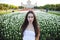 Young brunette women on the background of a glade of tulips flowers