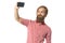 The young brutal man with a beard of the European appearance takes a selfie on a white background in a red shirt with braces and