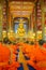 Young buddhist monks praying in Wat Suan Dok temple