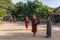 Young buddhist novices walk to collect alms and offerings on the streets of Bagan, Myanmar.