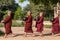 Young buddhist novices walk to collect alms and offerings on the streets of Bagan, Myanmar.