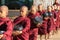 Young buddhist novices walk to collect alms and offerings on the streets of Bagan, Myanmar.