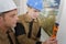 Young builder in hardhats with tools indoors