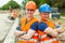 Young builders in helmets