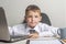 Young business boy is working in the office. A child disguised as a businessman. Funny kids