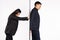 Young business gender partners separated by a wall. The businesswoman pushes the man behind the wall. White background