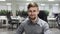 Young business man with a beard smiling at the workplace in office