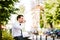 Young Business Man Flipping Through Book While Sitting Outdoor