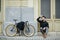 Young business man sitting on the floor with bicycle.Handsome man enjoying city ride by bicycle