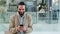 Young business man typing on phone in an office. Male is texting a joke, using social media, browsing the internet or