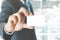 Young business man wear suit holding white business card