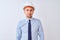 Young business man wearing contractor safety helmet over isolated background puffing cheeks with funny face