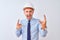 Young business man wearing contractor safety helmet over isolated background shouting with crazy expression doing rock symbol with