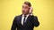 young business man wearing suit and tie  on yellow background