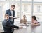 Young business people looking at laptop in meeting