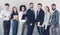 Young business team looking at camera in office