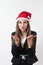 Young business woman blowing a kiss with a santa red christmas hat