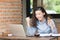 young business woman cheerful smile sitting at terrace cafe, enjoying online communication using free wireless internet connection