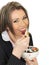 Young Business Woman Eating a Bowl of Cereals with Yogurt and Be