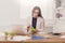 Young business woman eating salad at office