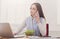 Young business woman eating salad at office