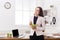 Young business woman eating salad at office