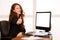 Young business woman gesture success show thumb up at her desk i