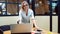 Young business woman in her office. Work in the office, a professional girl stands near the table with a laptop.