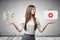 Young business woman holding bundles of dollars and first aid medical box in her hands on grey wall background.