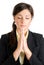 Young business woman praying