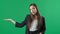 Young business woman presenting product on green background. Portrait of female professional pointing hand to copy space