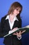 Young business woman reading a green file