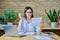 Young business woman reading an important letter, rejoicing at good news