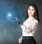 Young business woman with robot hand point on galaxy.