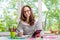 Young business woman sitting at table with tablet, remote work.