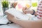 Young business woman sitting at table and taking notes in notebook during call for business financial consult