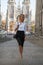 young business woman in white shirt standing in front of church