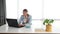 Young business woman working in the office on laptop listening the music on the headphones. Female businessperson enjoying her wor