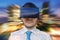 Young businessman is in 3D simulation of city. He is wearing virtual reality headset