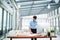 Young businessman or architect with model of a house standing in office, working.