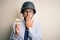 Young businessman with beard wearing helmet holding paper with war message cover mouth with hand shocked with shame for mistake,