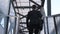 Young businessman in a black suit climbs the stairs up, rear view. The manager walks up the stairs