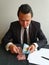 young businessman with black suit counting Costa Rican money