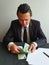 young businessman with black suit counting Israeli money