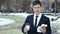 Young businessman with coffee and fast food in the hands. 4k