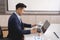 Young businessman concentrate working on laptop with white scree